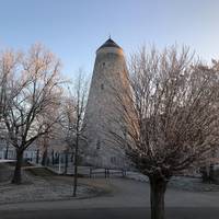 Soleturm hinter winterlichen Bäumen