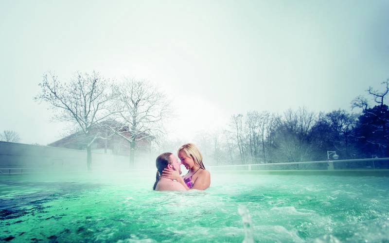 Solequell Außenbecken badendes Paar im Winter